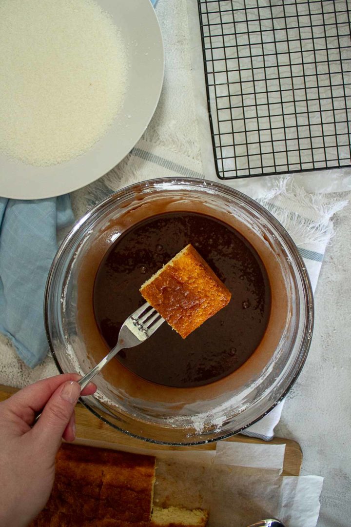 Dipping lamingtons in icing