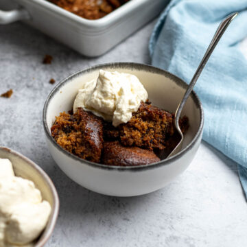Tipsy tart dished up into a bowl with some whipped cream.