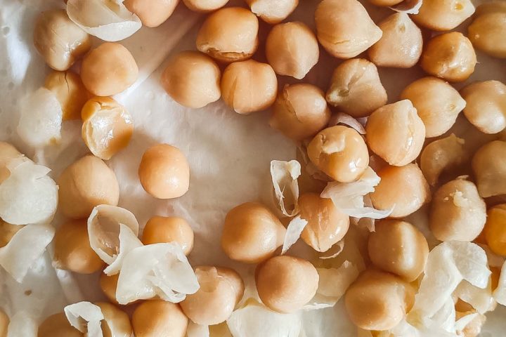 Chickpeas being peeled on a paper towel