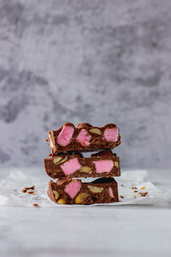 Chocolate Fish Rocky Road stacked on each other 3 high to show pink marshmallow and peanuts