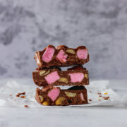 Chocolate Fish Rocky Road stacked on each other 3 high to show pink marshmallow and peanuts.