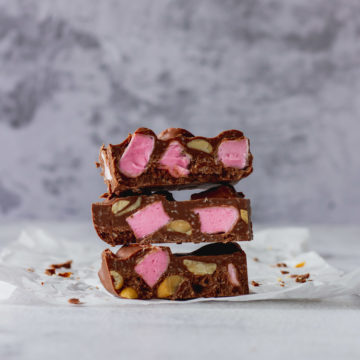 Chocolate Fish Rocky Road stacked on each other 3 high to show pink marshmallow and peanuts.
