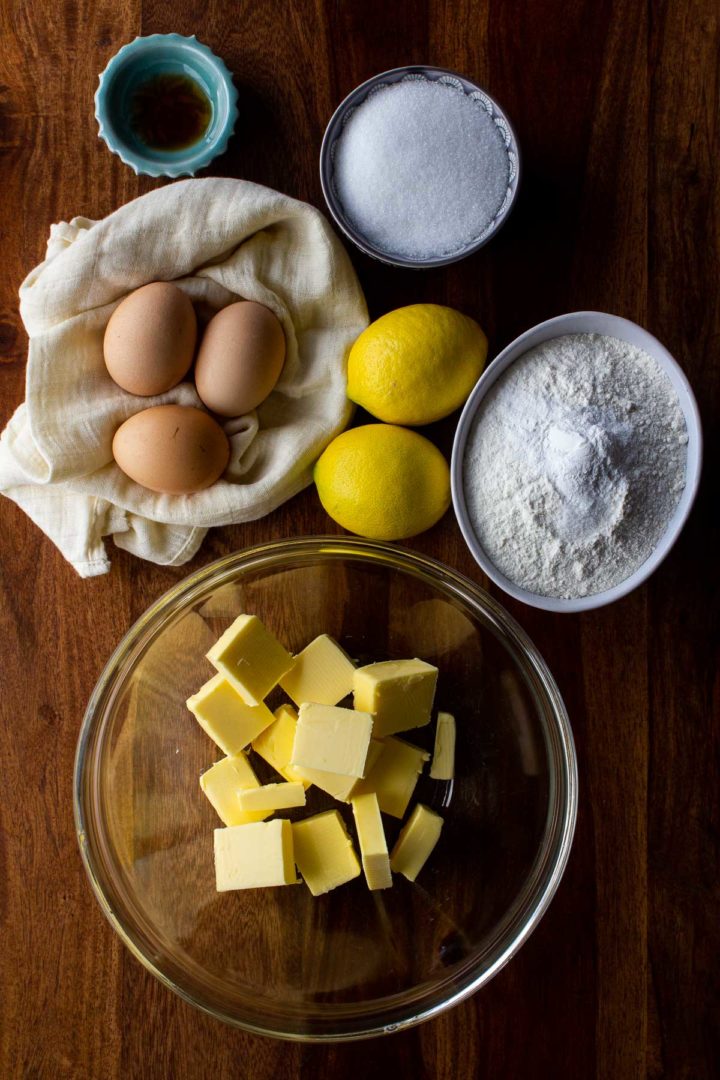 Lemon Cake Ingredients - eggs, vanilla, sugar, flour, lemons and butter