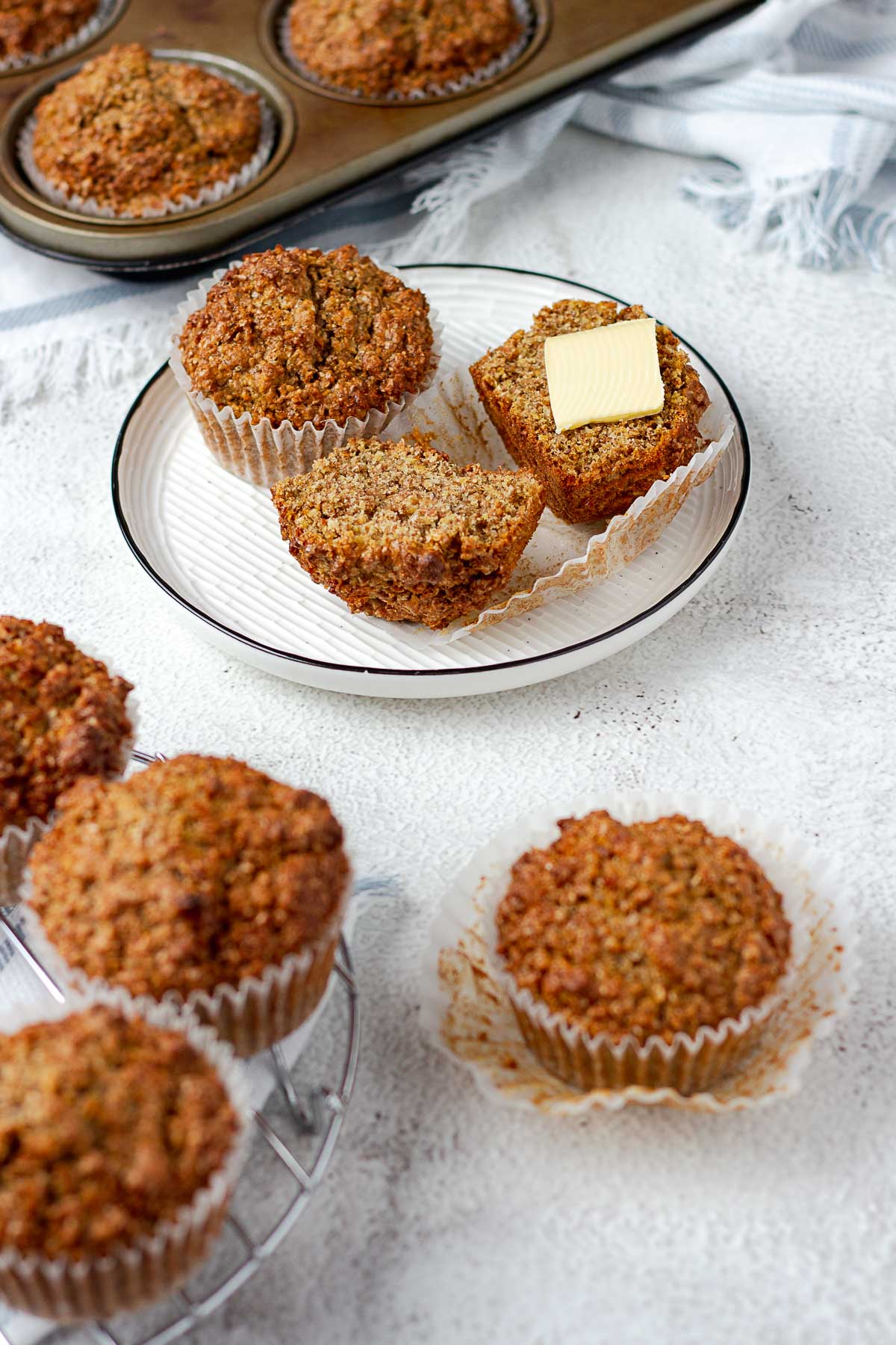 Bran muffins on a plate, sliced with a pat of butter