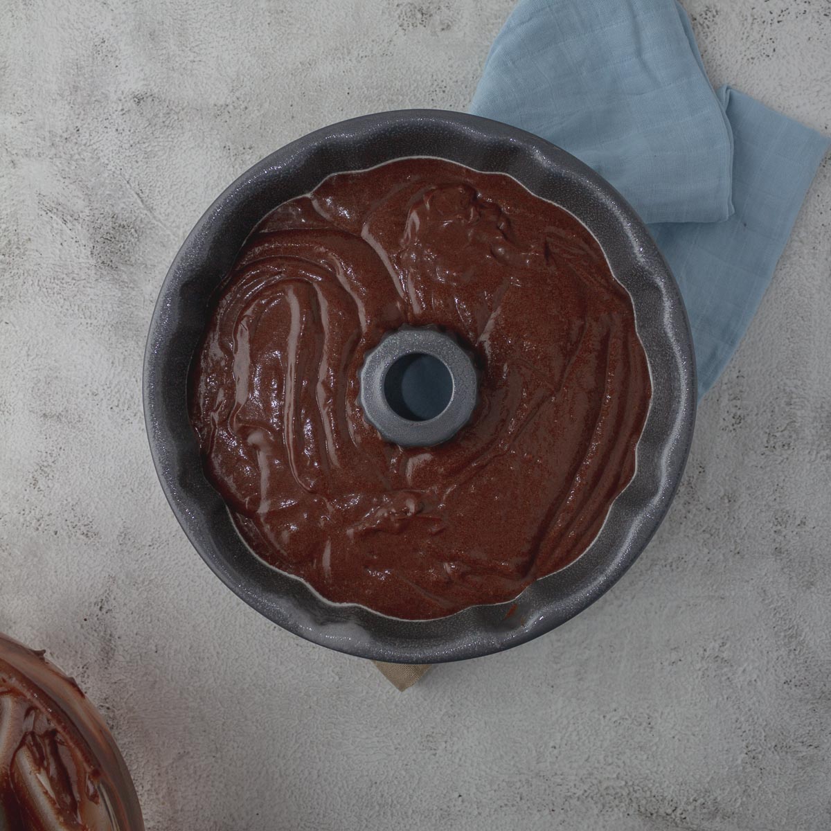 Chocolate bundt cake batter in bundt tin.