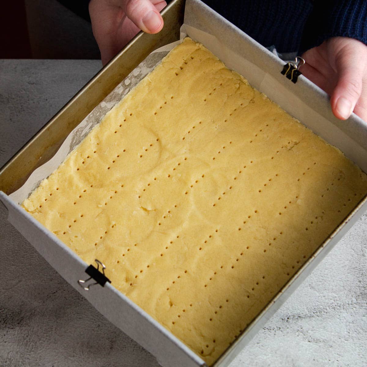 Whipped shortbread pressed into the pan and pricked with a fork