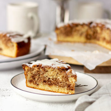 Slice of cinnamon roll cake on a plate.