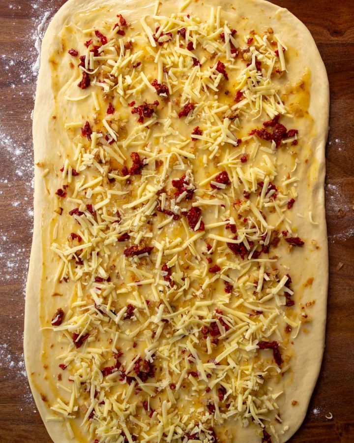 tep 6 - Dough rolled out and covered with fillings