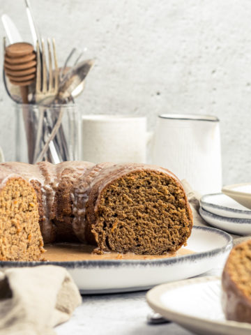 Sliced orange gingerbread cake with an spiced orange glaze showing the cake crumb.