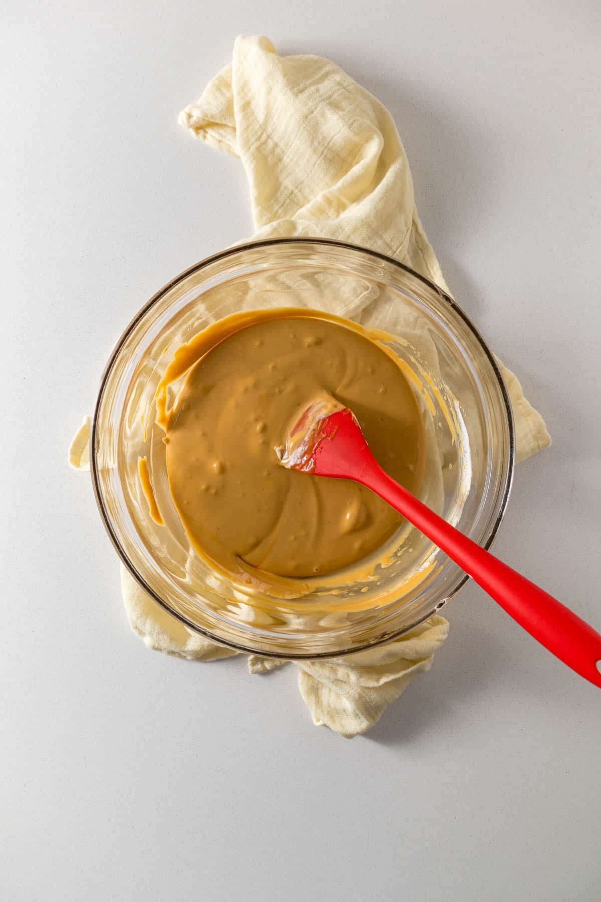 Step 2 - Two or three spoonfuls of cream mixed into the caramel to loosen it up in a small bowl.