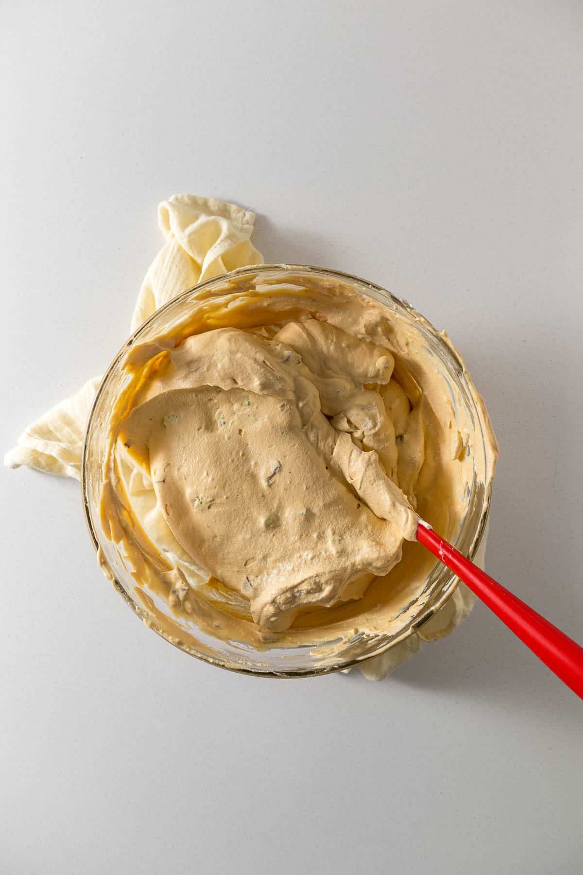 Step 3 - Peppermint crisp or aero mint pieces folded into the caramel-cream mixture in a large bowl.