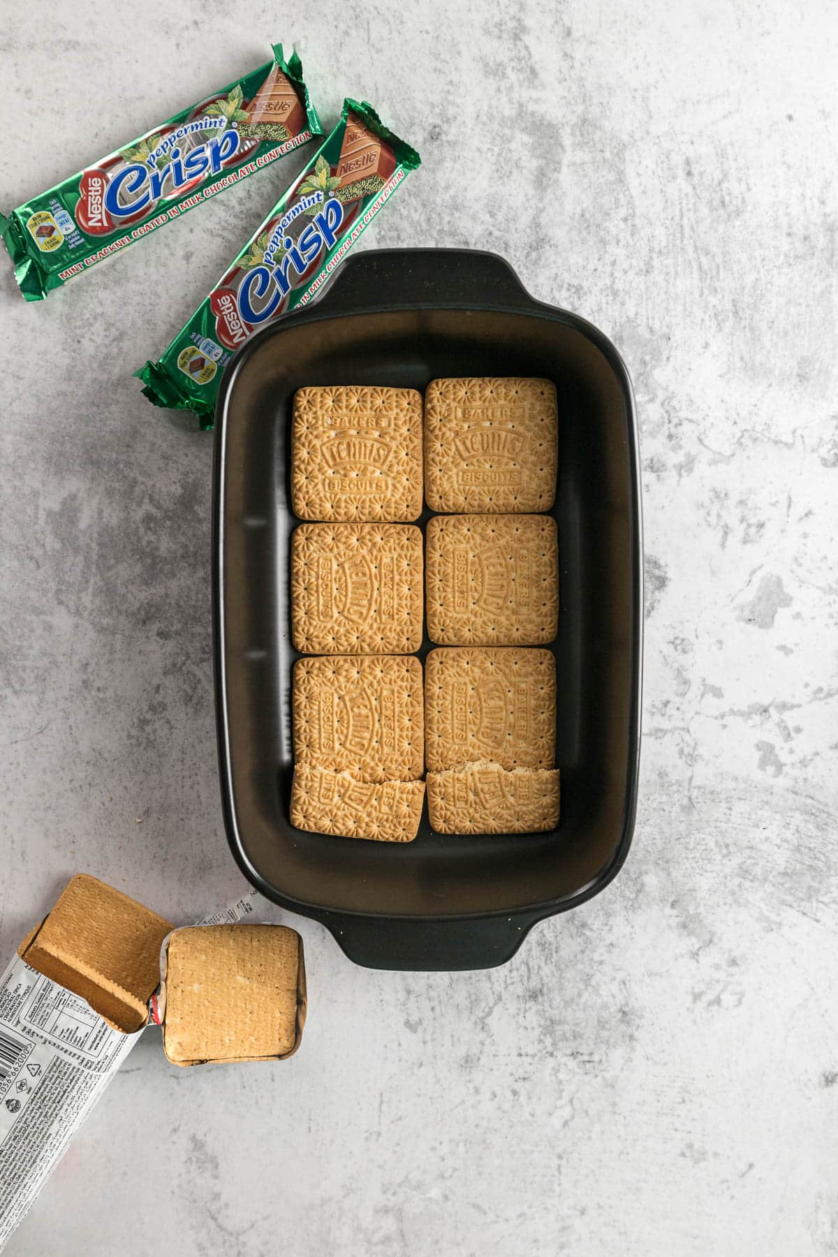 Step 4 - Tennis biscuits laid in the bottom of a dish.