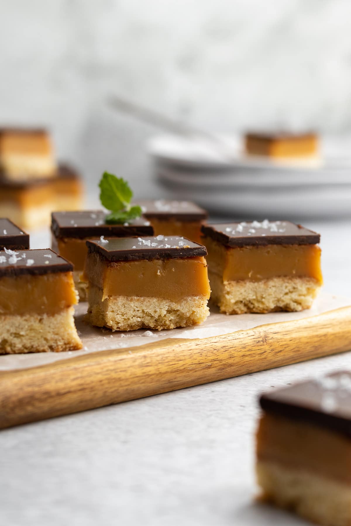 Peppermint crisp caramel slices on a board.