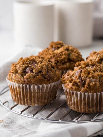 Banana Walnut Chocolate Chip Muffins on a cooling rack.