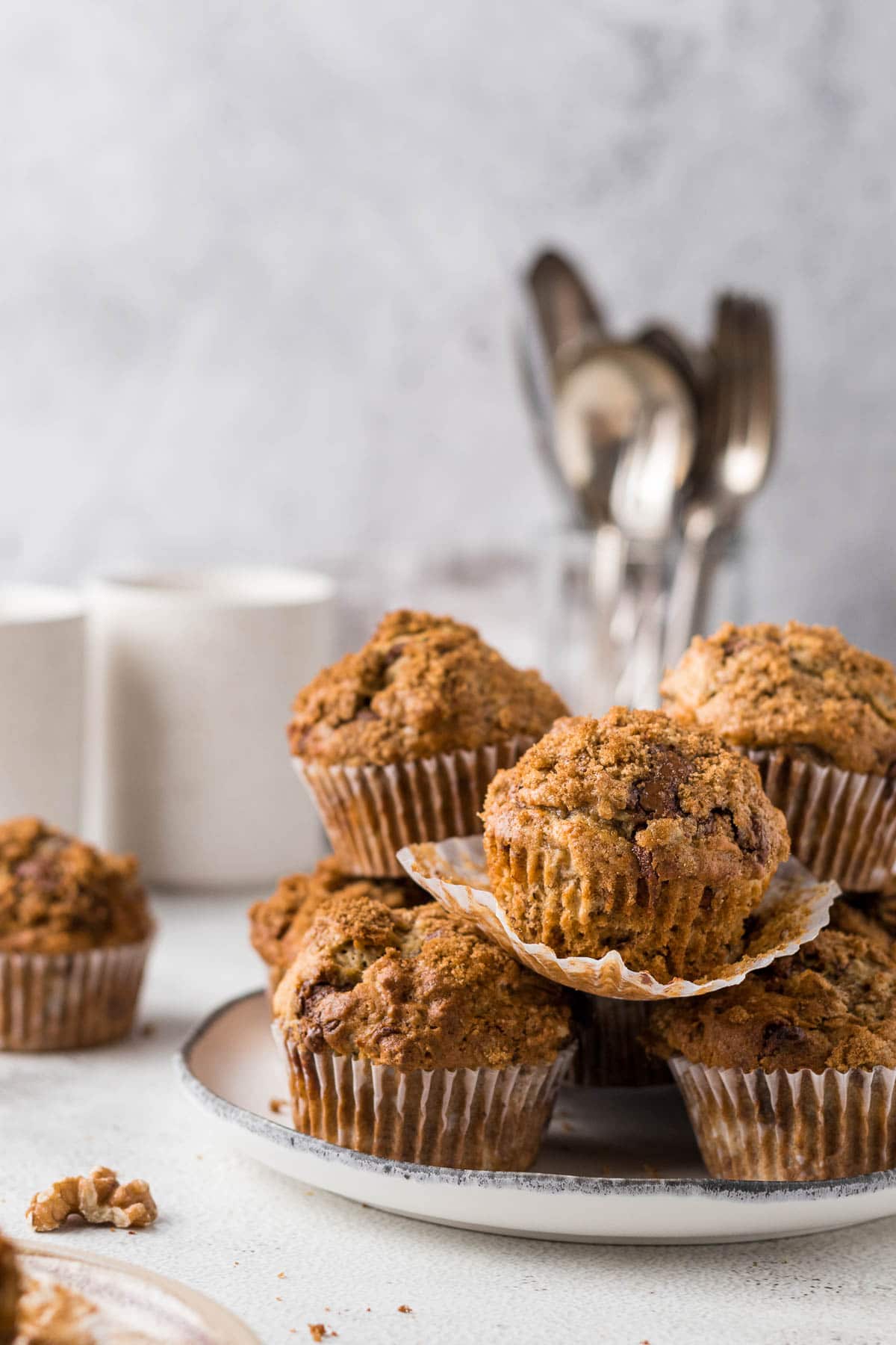 pile of banana walnut chocolate chip muffins on a plate