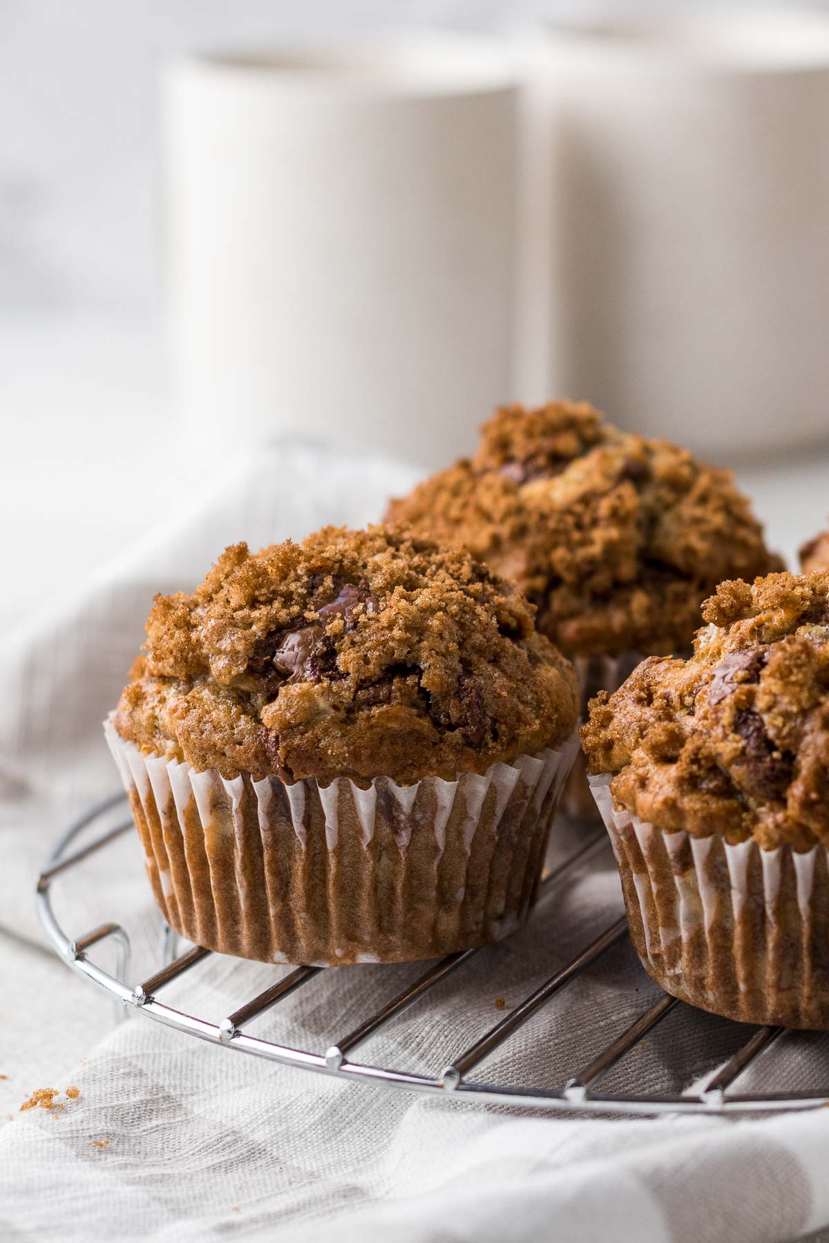 Banana Walnut Chocolate Chip Muffins on a cooling rack.