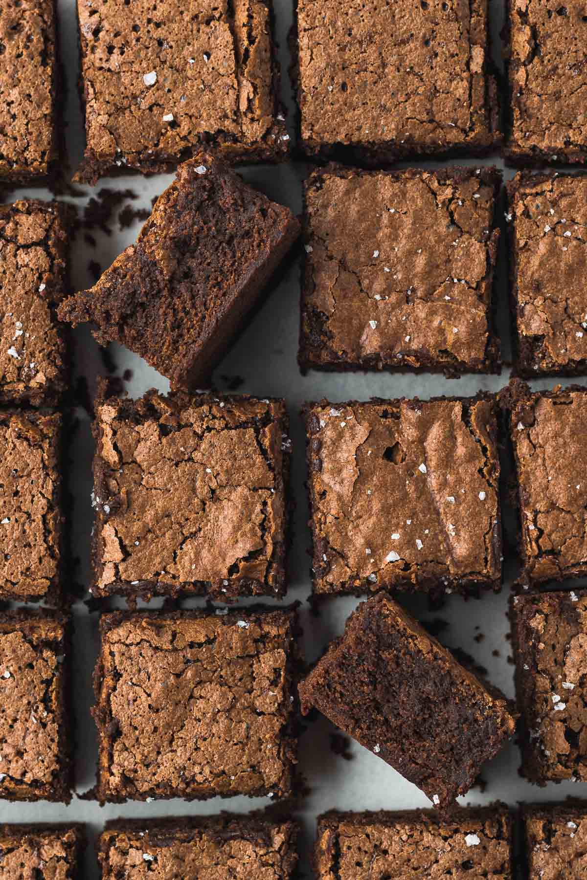 Chocolate Brownies slices and viewed from above, with two on their side showing chewy centres.