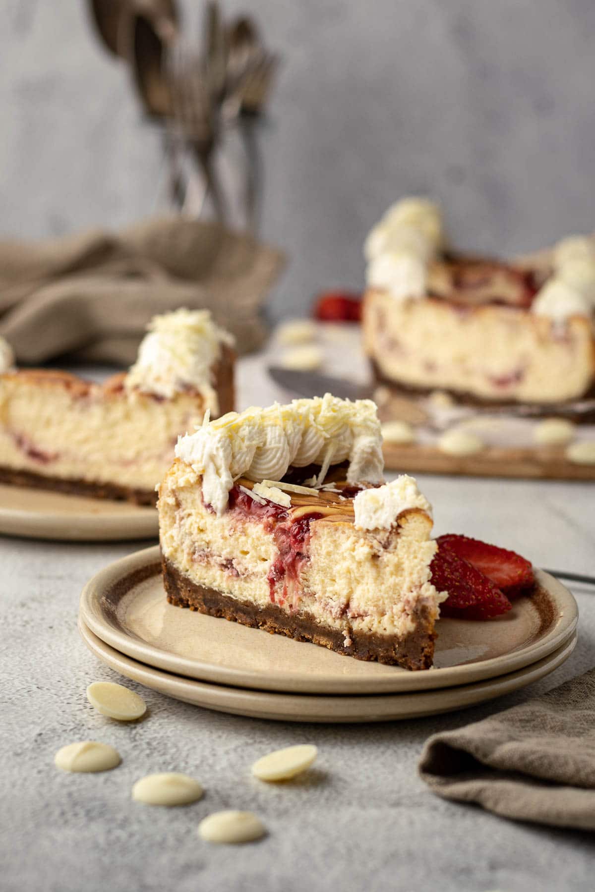 Slice of strawberry white chocolate cheese cake on a plate