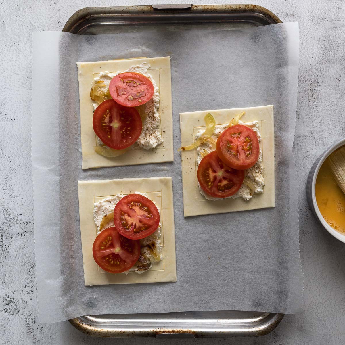 Step 4 - tomatoes placed over the ricotta and onions