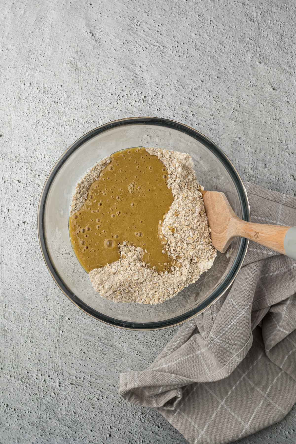 Wet ingredients added to dry ingredients in a bowl.