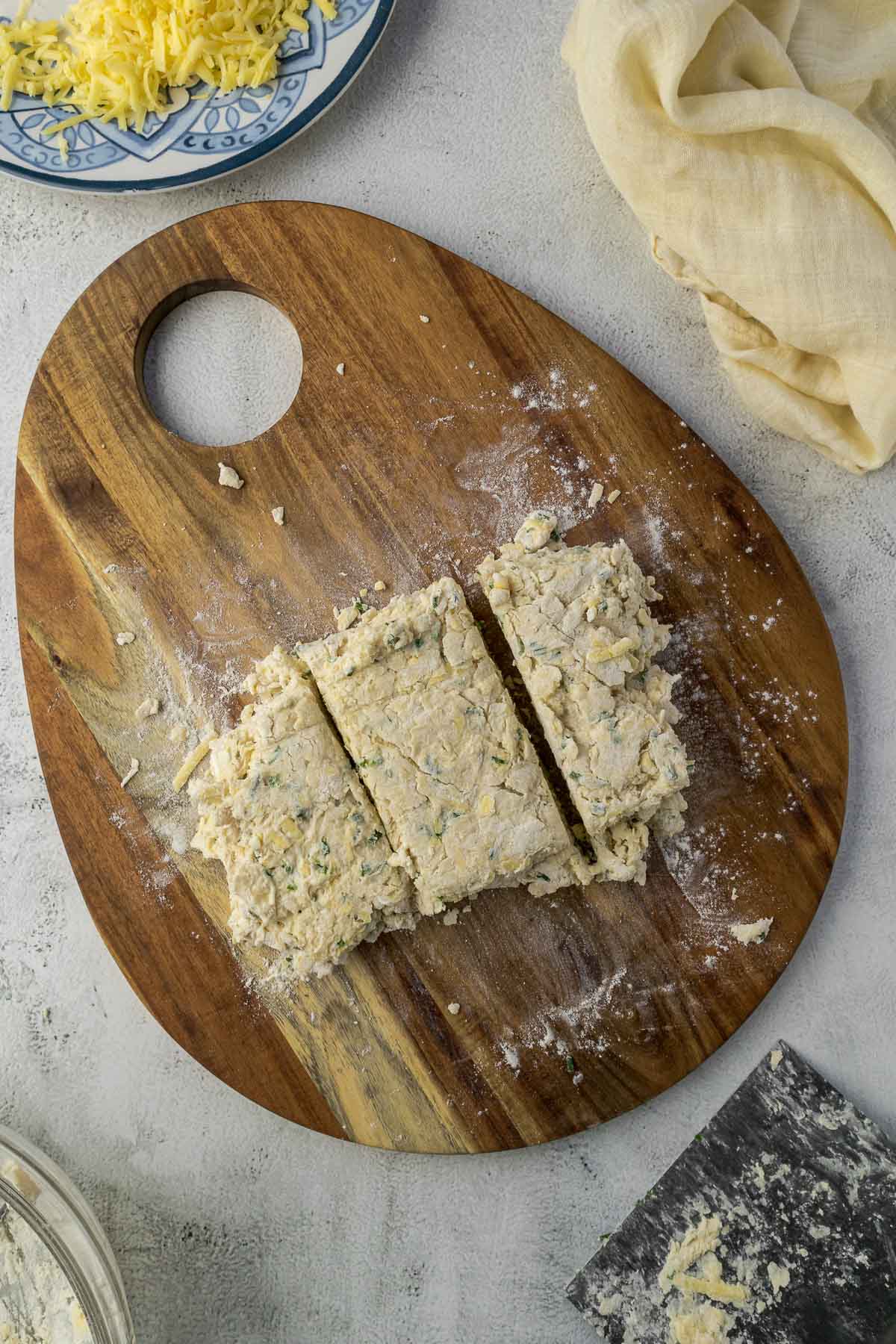 Scone dough patted into a rectangle and divided into 3 for lamination.