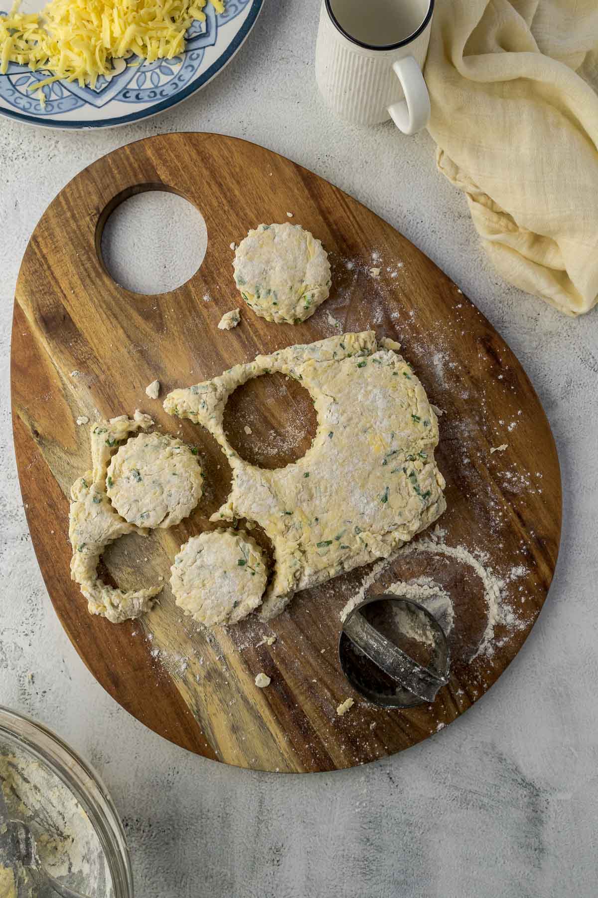 Round scones cut out the dough on a board.