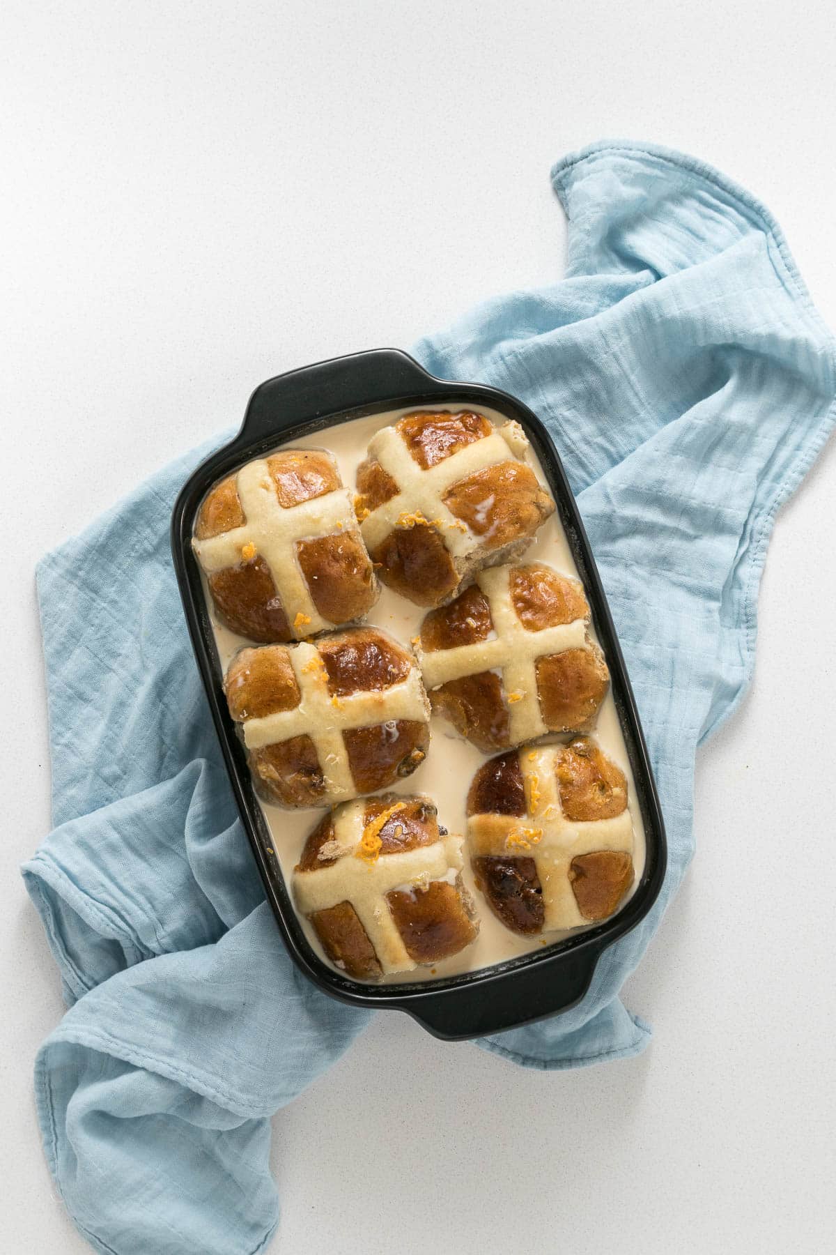 Step 4 - Buns placed in dish and covered with milk mixture.