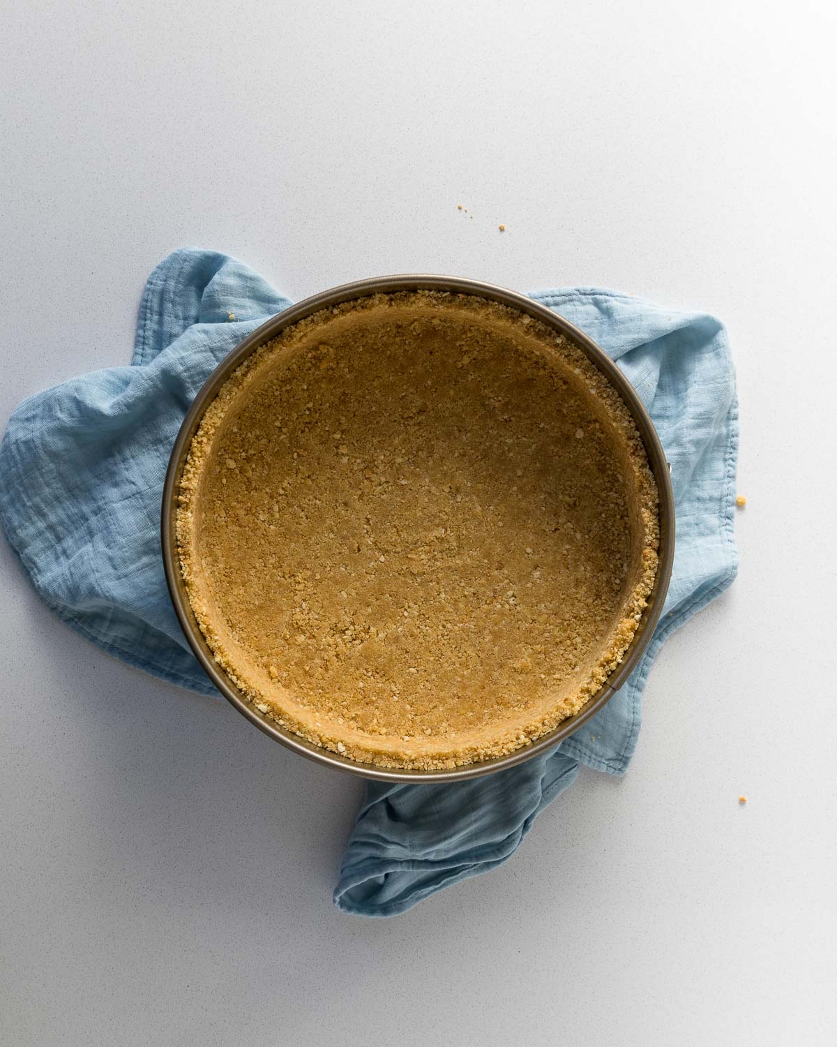 Biscuit base pressed into the tin.