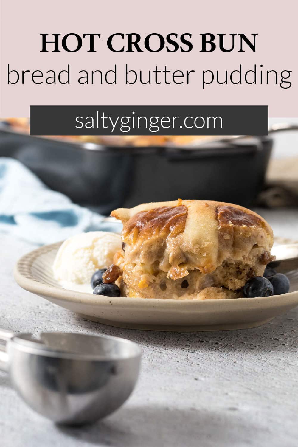 Serving of hot cross bun pudding on a plate with ice-cream