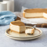 Slice of milk tart on a plate with a piece on a fork.