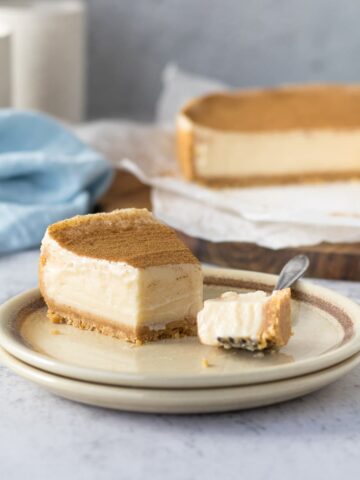Slice of milk tart on a plate with a piece on a fork.