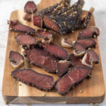 Sliced biltong on a board.