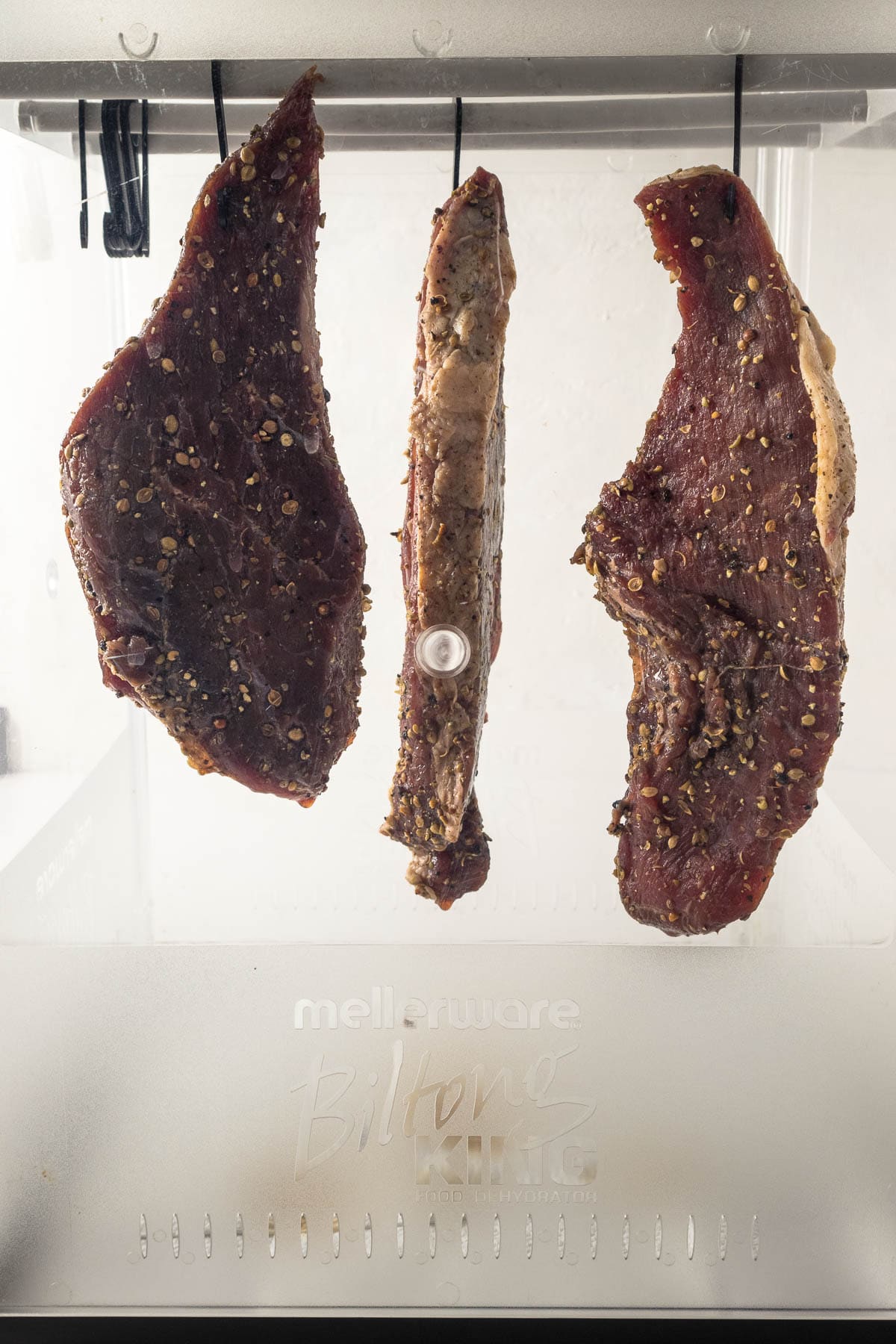 Biltong hung up in a biltong box.
