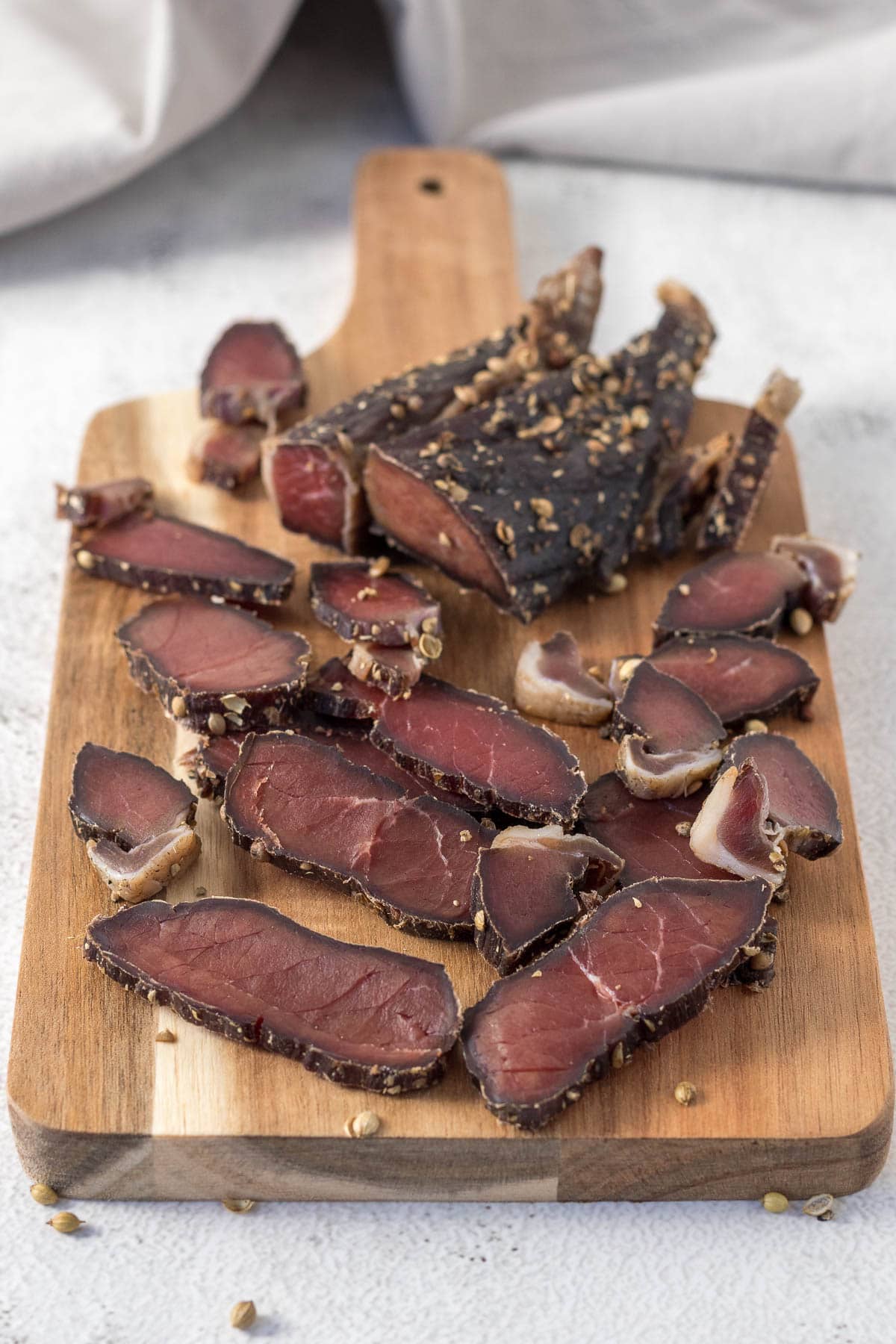 Sliced biltong on a board.