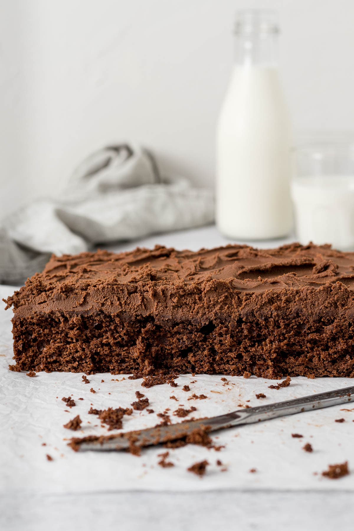 Sliced chocolate tray bake showing milk chocolate ganache.