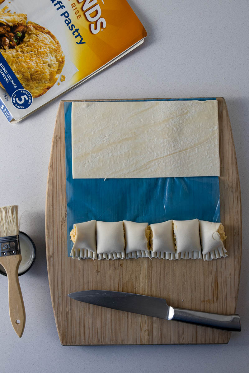 Unbaked cheese rolls crimped and cut.