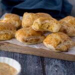 Mini cheese rolls on a serving platter.