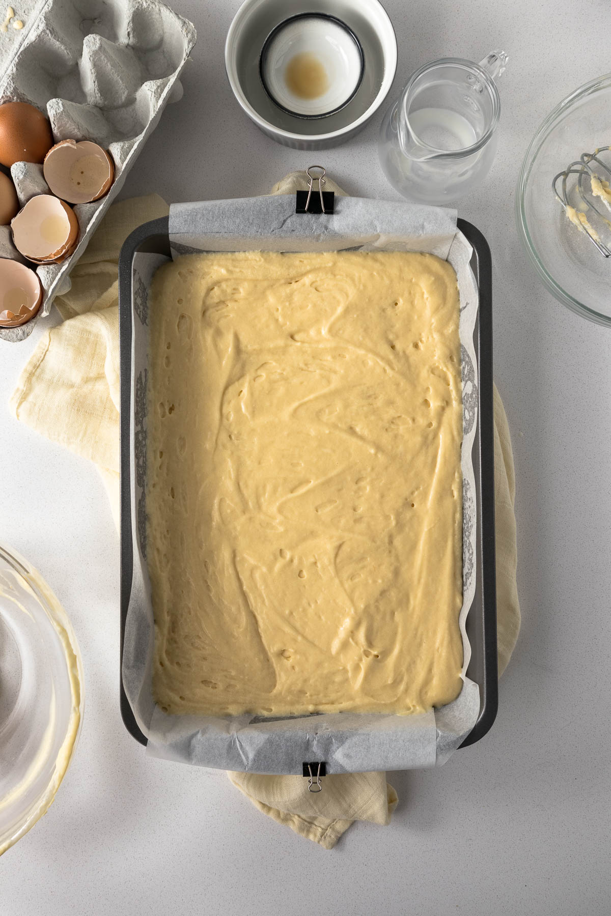 Vanilla cake batter in a rectangular cake tin.