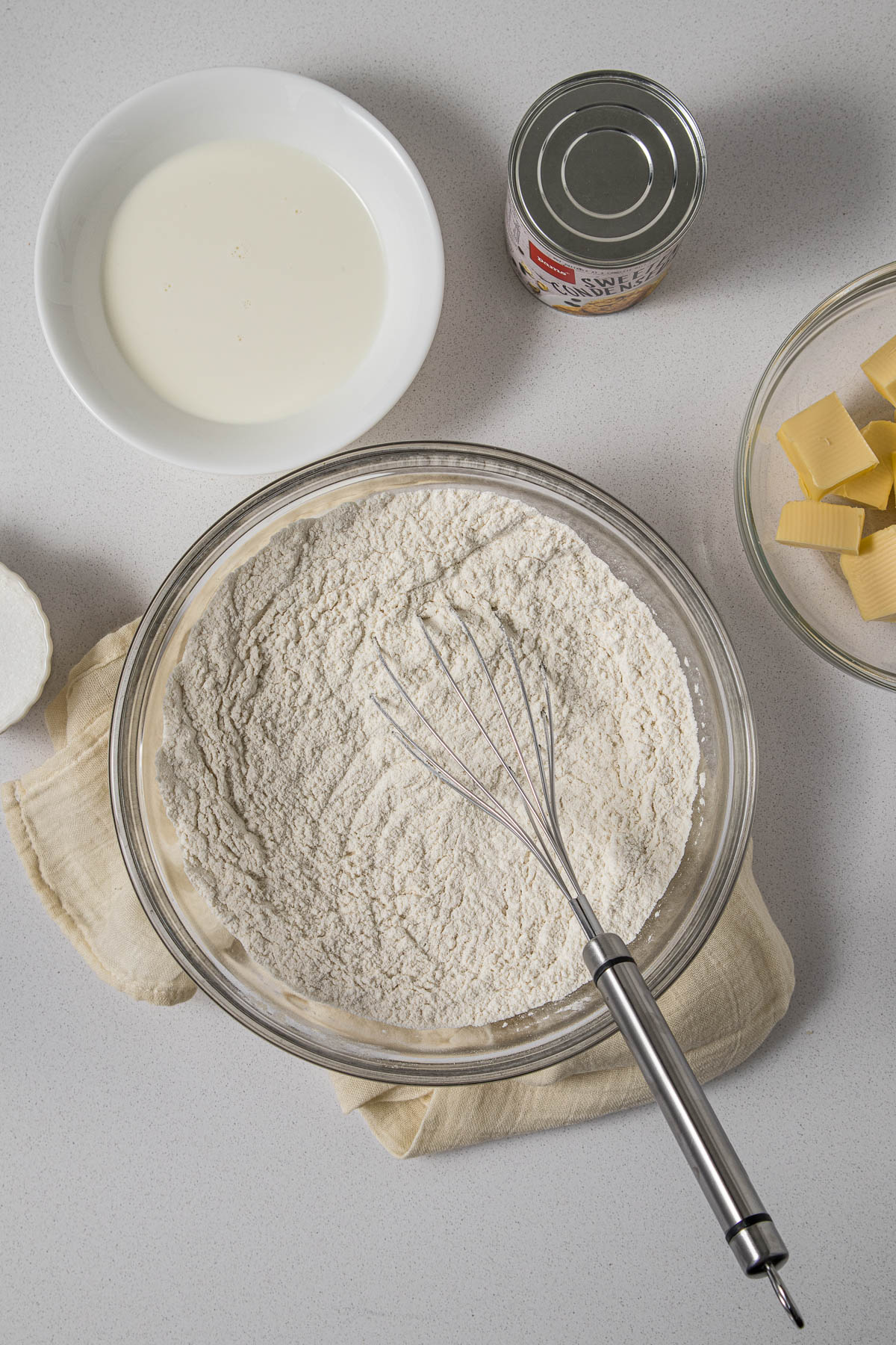 Baking soda, baking powder, and salt whisked through the flour.
