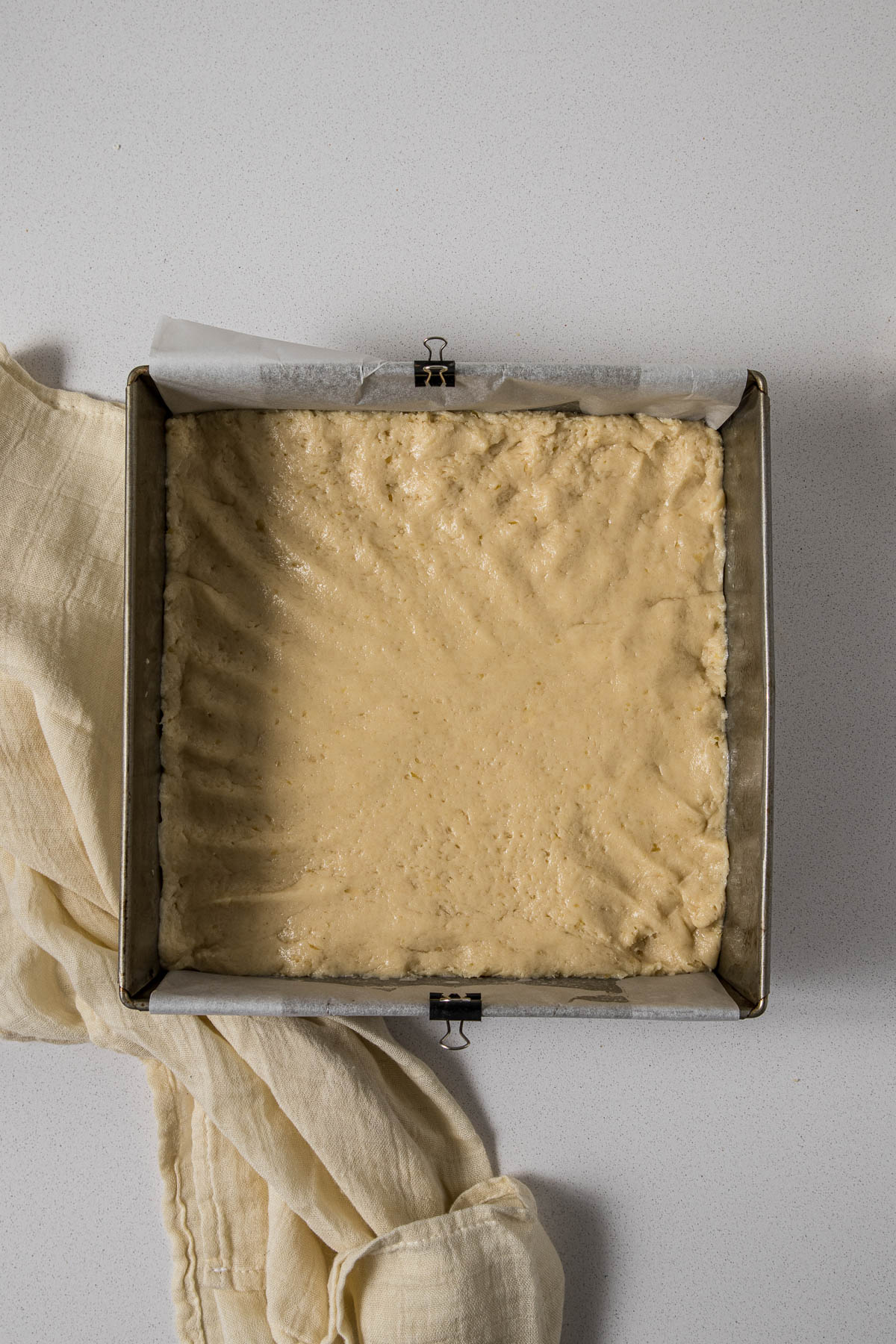 Step 5 - Condensed milk rusk dough pressed into a 9"x9" cake tin.