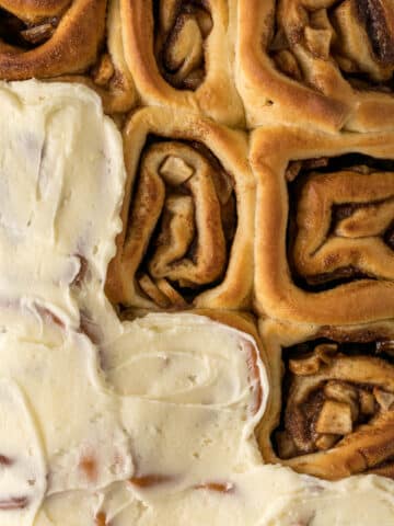 A tray of cinnamon rolls with apple pie filling.