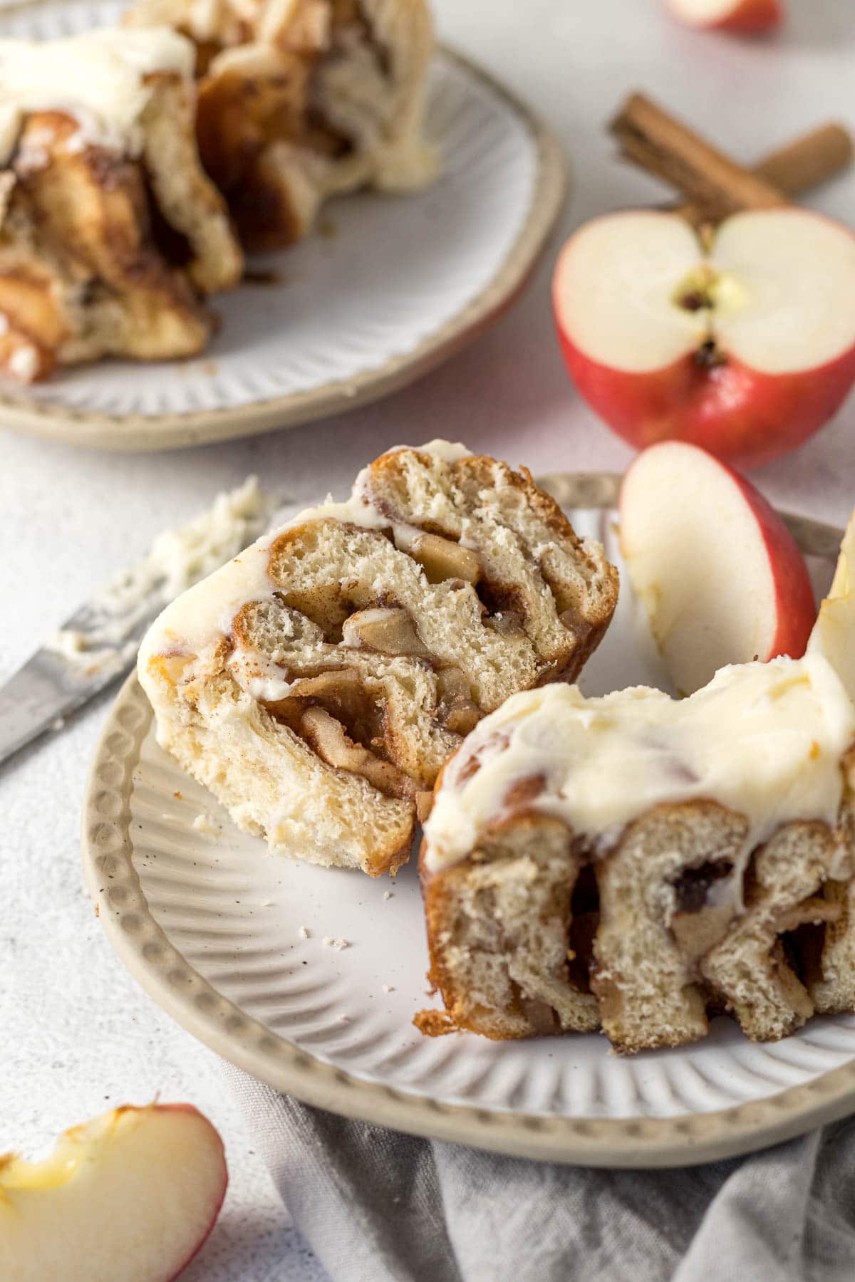 Cinnamon roll with apple pie filling sliced in half.