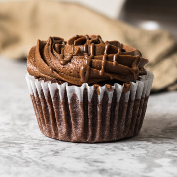 Frosted nutella cupcake with a Nutella drizzle.