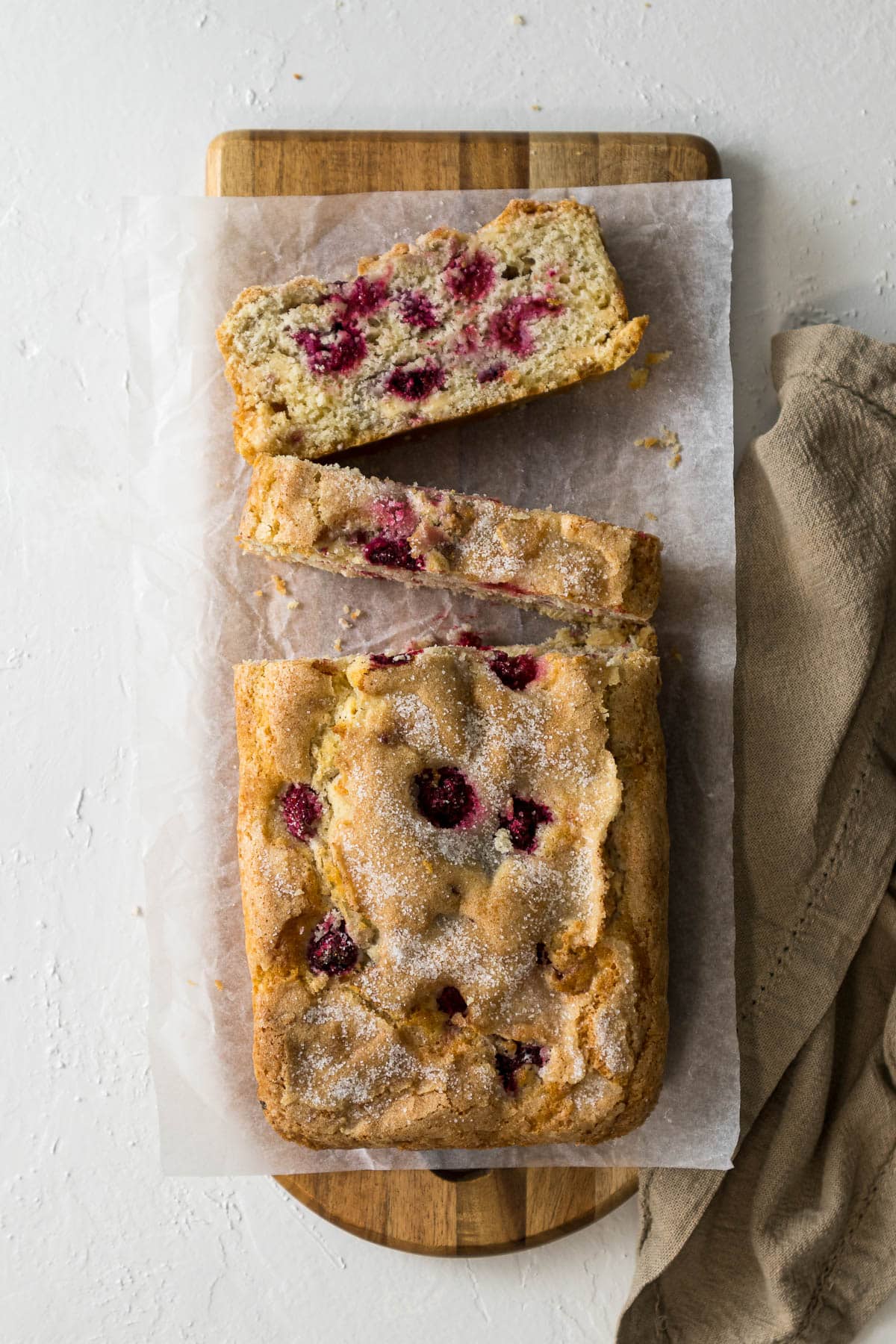 Raspberry and white chocolate loaf cake sliced.