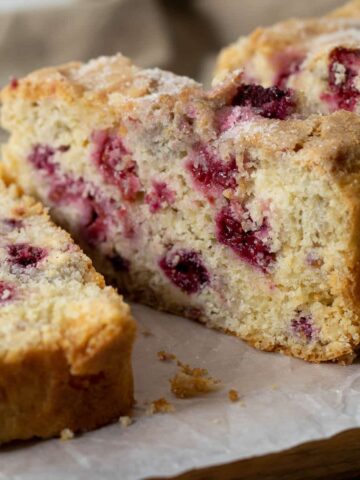 Slice of raspberry and white chocolate loaf cake.