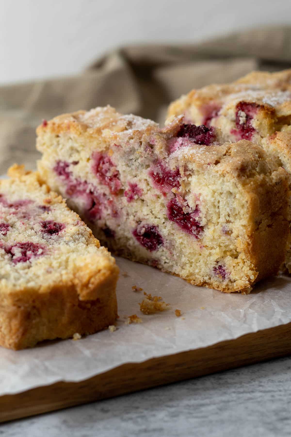 Slice of raspberry and white chocolate loaf cake.