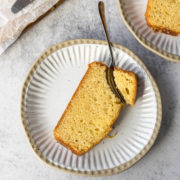 Slice of orange loaf cake on a plate.