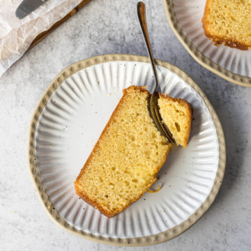 Slice of orange loaf cake on a plate.