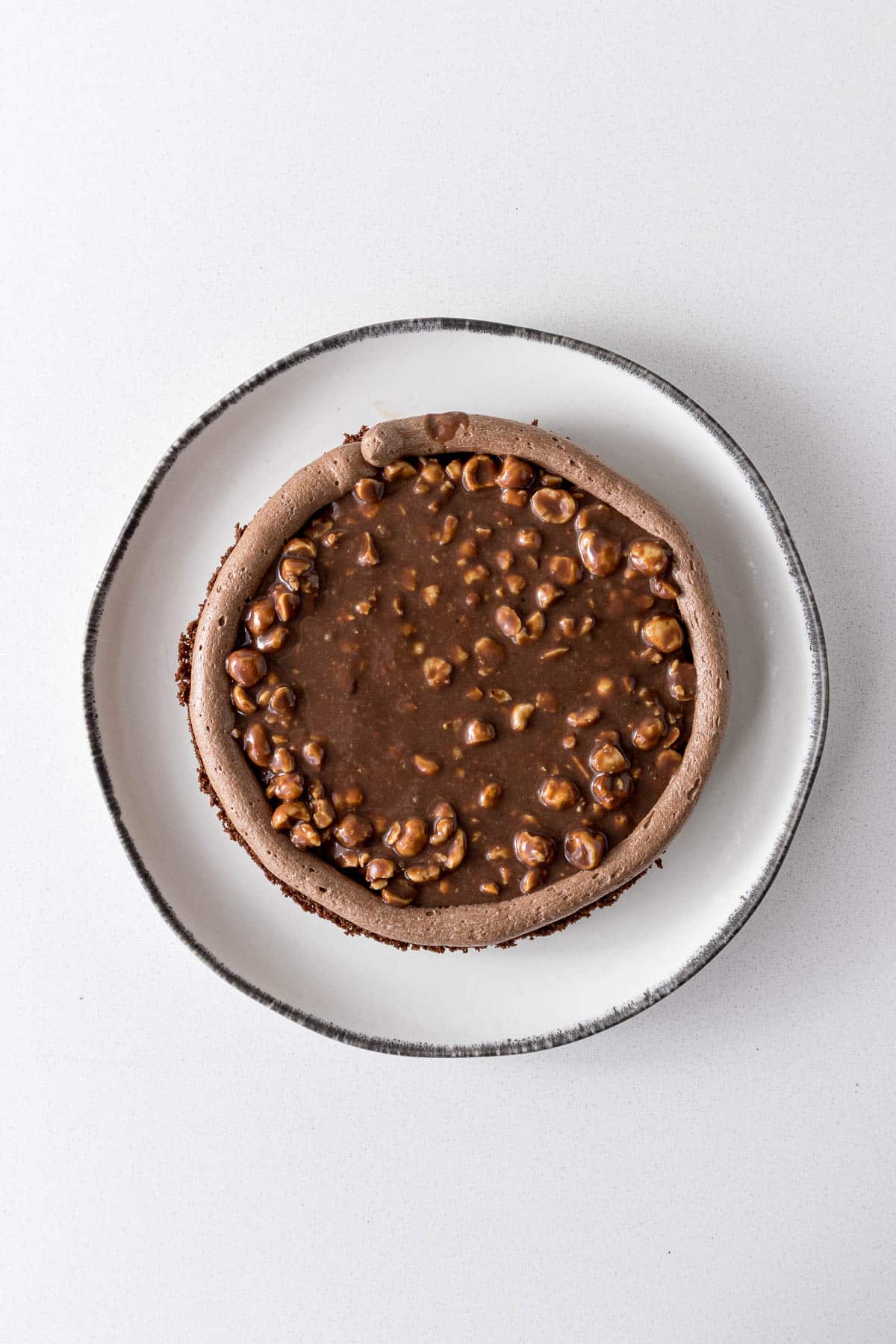 Ganache flooded inside the Nutella frosting border.