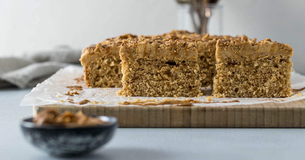 Sliced Biscoff cake on a board.